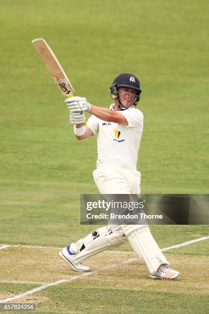 Marcus Harris of the Bushrangers hits for six during the Sheffield Shield final between Victoria and South Australia on March 26, 2017 in Alice...