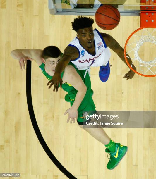 Casey Benson of the Oregon Ducks and Lagerald Vick of the Kansas Jayhawks battle for the ball during the 2017 NCAA Men's Basketball Tournament...