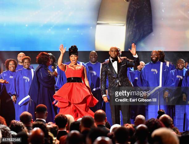 Co-hosts Erica Campbell and Anthony Brown wave to the audience as The Chicago Mass Choir performs during the 32nd annual Stellar Gospel Music Awards...