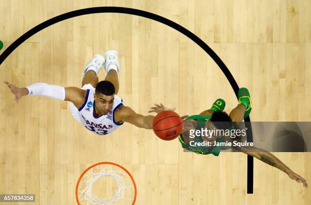 Landen Lucas of the Kansas Jayhawks and Tyler Dorsey of the Oregon Ducks battle for the ball during the 2017 NCAA Men's Basketball Tournament Midwest...