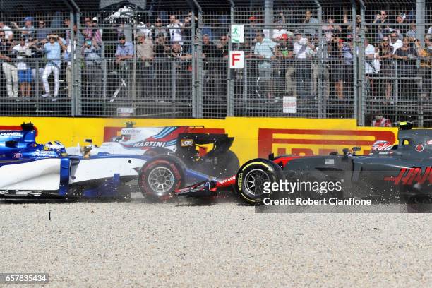 Marcus Ericsson of Sweden driving the Sauber F1 Team Sauber C36 Ferrari tangles with Kevin Magnussen of Denmark driving the Haas F1 Team Haas-Ferrari...