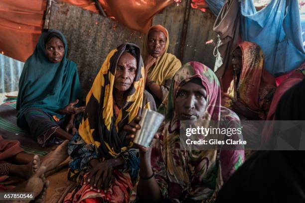 March 6, 2017: Elderly Internally Displaced Women huddle in a tent in a camp in central Mogadishu. Somalia is in the grip of an intense drought,...