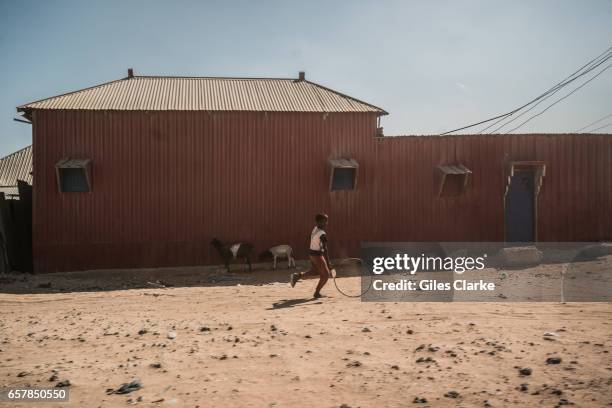 March 6, 2017: A young boy runs through the street in Mogadishu, Somalia. Somalia is in the grip of an intense drought, induced by consecutive...