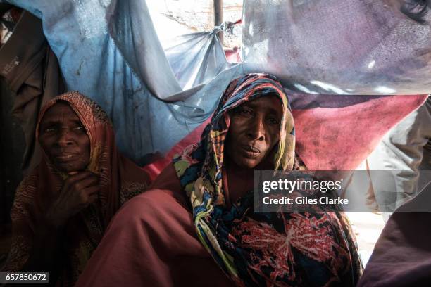 March 6, 2017: Elderly Internally Displaced Women huddle in a tent in a camp in central Mogadishu. Somalia is in the grip of an intense drought,...