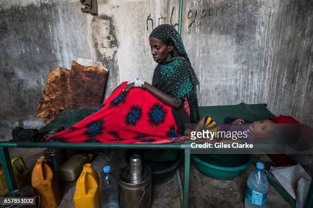 March 8, 2017: A cholera-stricken woman with her baby in a former prison in Wajid, Somalia. Somalia is in the grip of an intense drought, induced by...
