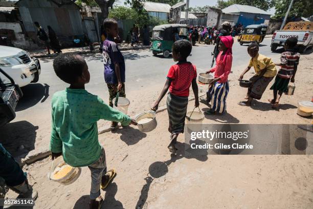 Children leaving a World Food Program 'wet food' center in Mogadishu. Somalia is in the grip of an intense drought, induced by consecutive seasons of...