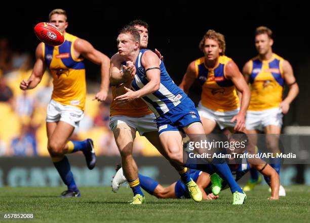 Jack Ziebell of the Kangaroos handpasses the ball ahead of lswc=\ during the 2017 AFL round 01 match between the North Melbourne Kangaroos and the...