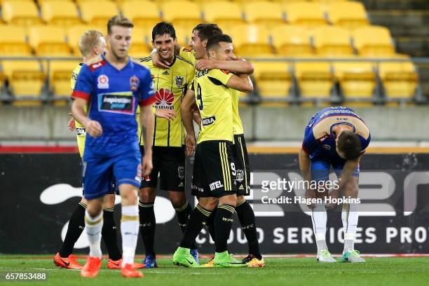 Gui Finkler celebrates his goal with teammates Alex Rodriguez and Kosta Barbarouses during the round 24 A-League match between Wellington Phoenix and...