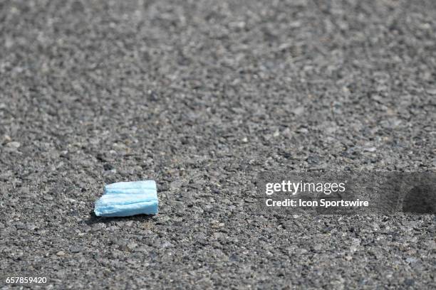 Debris rest on the track after flying out of the back of the Florida Watermelon Association Chevrolet driven by Ross Chastain causing a caution flag...