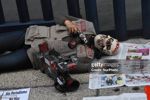 Woman simulates the murder of a journalist during a protest against of journalists murdered in Mexico at Reforma Avenue on March 25, 2017 in Mexico...