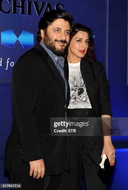 Indian Bollywood actress Sonali Bendre poses with her husband Goldie Behl as they attend a "Chivas 18 Alchemy" promotional event in Mumbai on March...