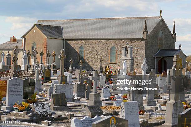 traditional irist cemetery by church kilkenny ire. - kilkenny ireland stock pictures, royalty-free photos & images