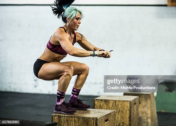 woman doing box jumps at crossfire gym - momo challenge stock pictures, royalty-free photos & images