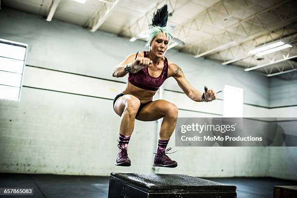 woman doing box jumps at crossfire gym - momo challenge stock pictures, royalty-free photos & images