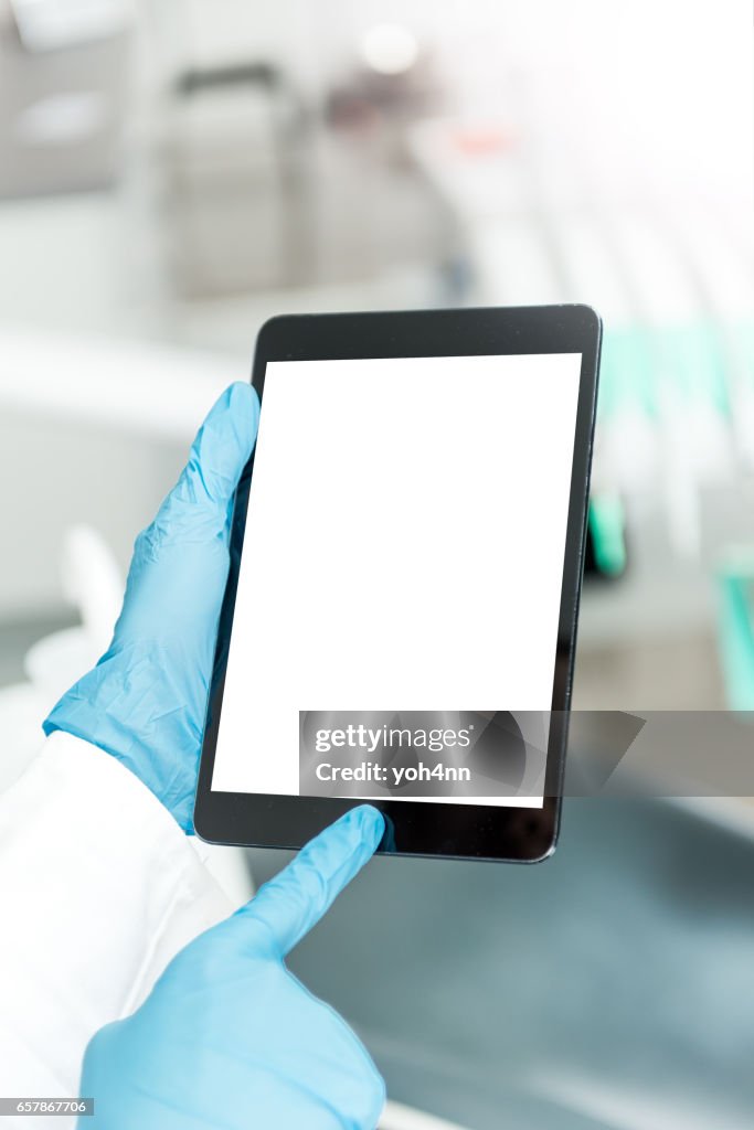 Dentist using blank screen tablet