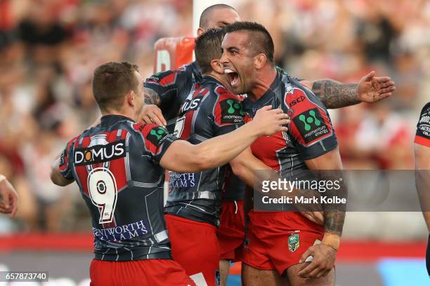Paul Vaughan of the Dragons celebrates with his team mates after scoring a try during the round four NRL match between the St George Illawarra...