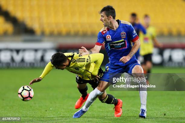 Logan Rogerson of the Phoenix is tackled by Jason Hoffman of the Jets during the round 24 A-League match between Wellington Phoenix and Newcastle...