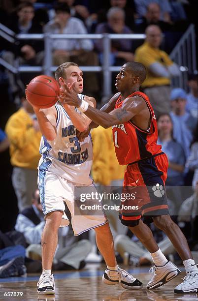 Brian Morrison of the University of North Carolina Tar Heels moves to keep the ball safe against Will Solomon of the Clemson Tigers during the game...