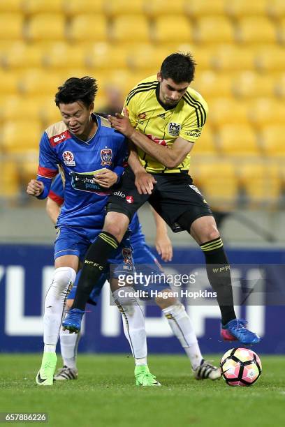 Gui Finkler of the Phoenix and Ma Leilei of the Jets collide during the round 24 A-League match between Wellington Phoenix and Newcastle Jets at...
