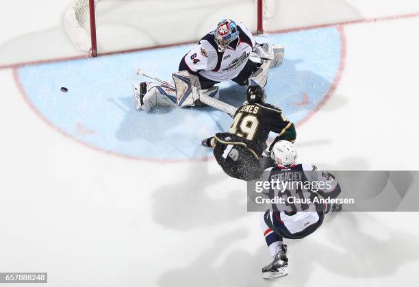 Max Jones of the London Knights just misses tipping a puck past Michael DiPietro of the Windsor Spitfires during Game One of the OHL Western...