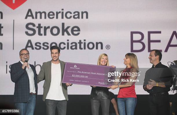 Hil Davis, Founder & CEO BeautyKind presents a check to the American Heart Association during BeautyKind Unites: Concert for Causes at AT&T Stadium...