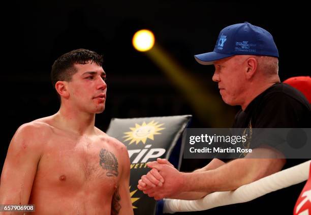 Vincenzo Gualtieri of Germany gets instructions by coach Graciano Rocchigiani after the middleweight fight at MBS Arena on March 25, 2017 in Potsdam,...