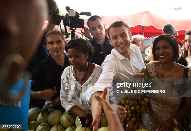 French presidential election candidate for the En Marche! movement Emmanuel Macron , flanked by member of the National Assembly Monique Orphe ,...