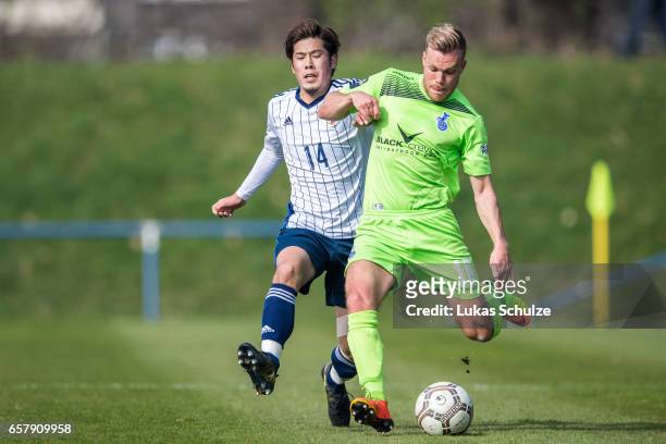 Akito Takagi of Japan and Fabio Leutenecker of Duisburg in action during a Friendly Match between MSV Duisburg and the U20 Japan on March 26, 2017 in...