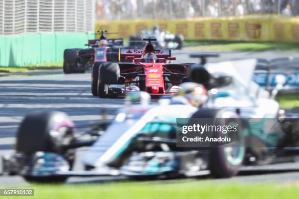 Sebastian Vettel of Germany, driving for Scuderia Ferrari, chases Lewis Hamilton of the United Kingdom, driving for Mercedes AMG Petronas, during the...