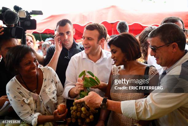 French presidential election candidate for the En Marche! movement Emmanuel Macron , flanked by member of the National Assembly Monique Orphe ,...