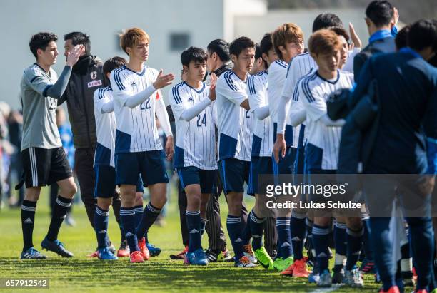 Takefusa Kubo of Japan and team mates shake hands after winning a Friendly Match between MSV Duisburg and the U20 Japan on March 26, 2017 in...