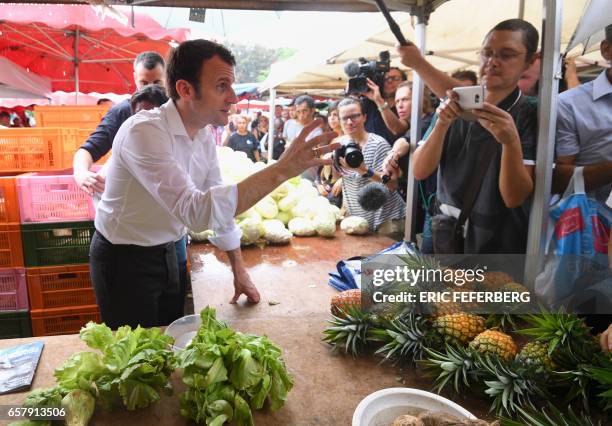 French presidential election candidate for the En Marche! movement Emmanuel Macron speaks with members of the public during a visit to Le Chaudron...