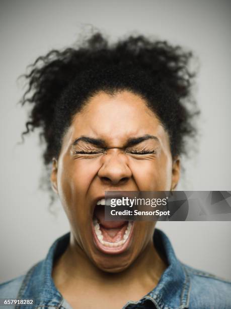 close-up portrait of a shocked real young afro american woman - angry black woman stock pictures, royalty-free photos & images