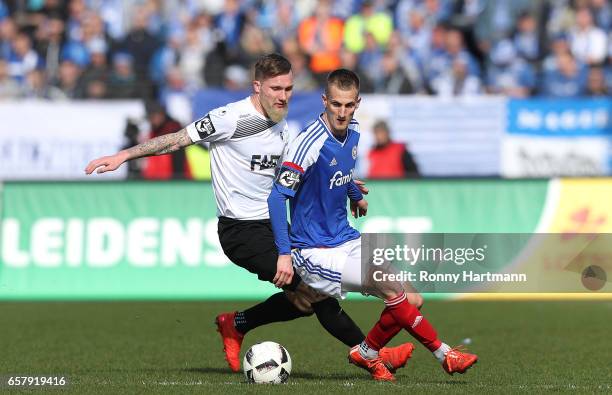 Jan Loehmannsroeben of Magdeburg and Dominick Drexler of Kiel vie during the Third League match between Holstein Kiel and 1. FC Magdeburg at...