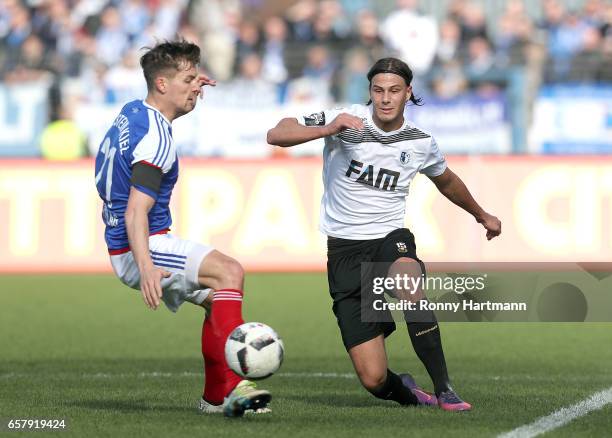 Tobias Schwede of Magdeburg and Tim Siedschlag of Kiel vie during the Third League match between Holstein Kiel and 1. FC Magdeburg at...