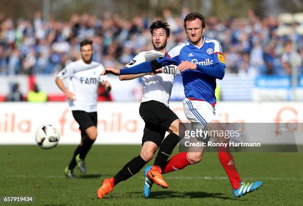Marius Sowislo of Magdeburg and Dominic Peitz of Kiel vie during the Third League match between Holstein Kiel and 1. FC Magdeburg at Holstein-Stadion...