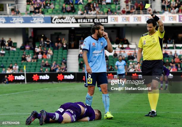 Referee Kris Griffiths-Jones issues a yellow card againt Joshua Brillante of Sydney FC during the round 24 A-League match between Perth Glory and...