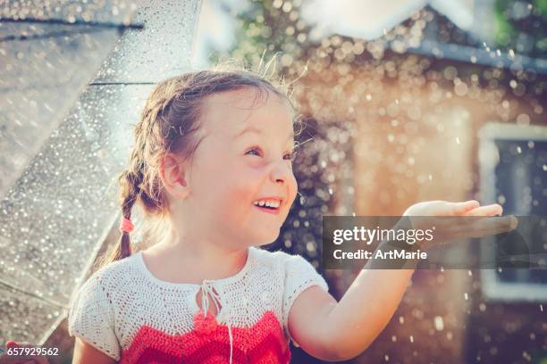 happy girl in rain - girl in shower stock pictures, royalty-free photos & images