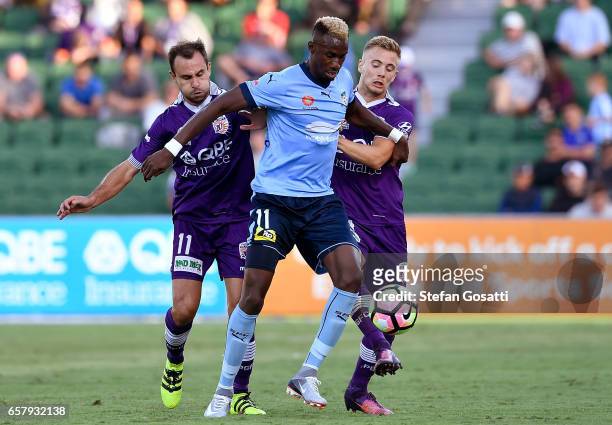 Bernie Ibini of Sydney FC contests the ball against Joseph Mills and Richard Garcia of the Glory during the round 24 A-League match between Perth...