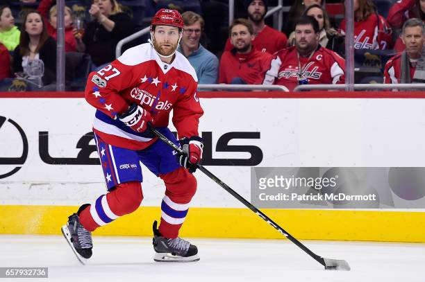 Karl Alzner of the Washington Capitals skates with the puck against the Columbus Blue Jackets in the first period during an NHL game at Verizon...