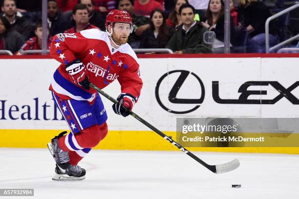 Karl Alzner of the Washington Capitals skates with the puck against the Columbus Blue Jackets in the first period during an NHL game at Verizon...