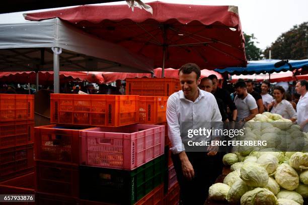 French presidential election candidate for the En Marche! movement Emmanuel Macron visits the Le Chaudron market on March 26, 2017 in Saint-Denis, as...