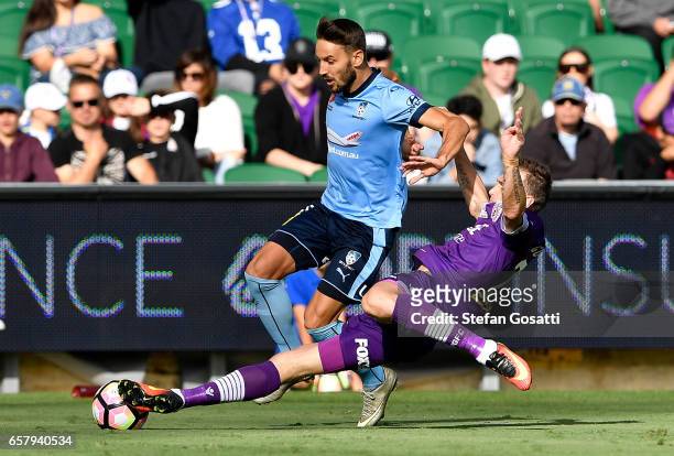 Milos Ninkovic of Sydney FC and Lucian Goian of the Glory contest the ball during the round 24 A-League match between Perth Glory and Sydney FC at...