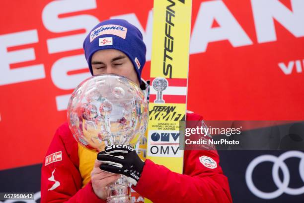 Stefan Kraft of AUT the overall winner, celebrates with trophies for ski flying and ski jumping during Planica FIS Ski Jumping World Cup...