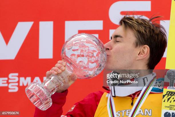 Stefan Kraft of AUT the overall winner, celebrates with trophies for ski flying and ski jumping during Planica FIS Ski Jumping World Cup...