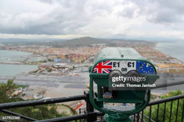 view from rock of gibraltar towards spain with storm clouds and a telescope showing uk and the eu, gibraltar - brexit fotografías e imágenes de stock