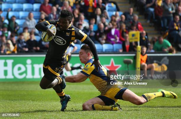 Christian Wade of Wasps beats a tackle from Josh Adams of Worcester Warriors on his way to scoring their second try during the Aviva Premiership...