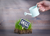 Skill concept. Fresh and green grass on wood background