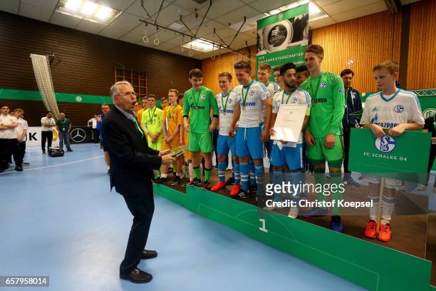 Doktor Hans-Dieter Drewitz, vice president of German Football Association hands out the winning trophy to the team of FC Schalke 04 of the B Juniors...
