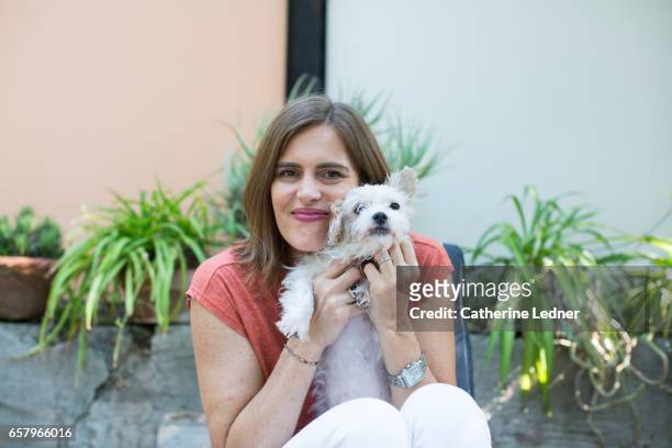 woman snuggling small dog - south pasadena california stock pictures, royalty-free photos & images